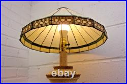 Victorian-era slag glass table lamp with a decorative metal base 1910