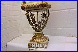 Victorian-era slag glass table lamp with a decorative metal base 1910