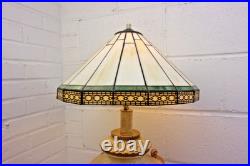 Victorian-era slag glass table lamp with a decorative metal base 1910